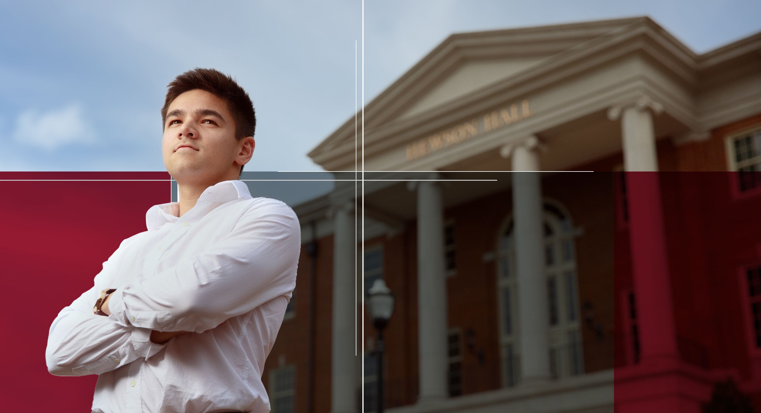 Nathan Yamaguchi stands, arms crossed, in front of Hewson Hall