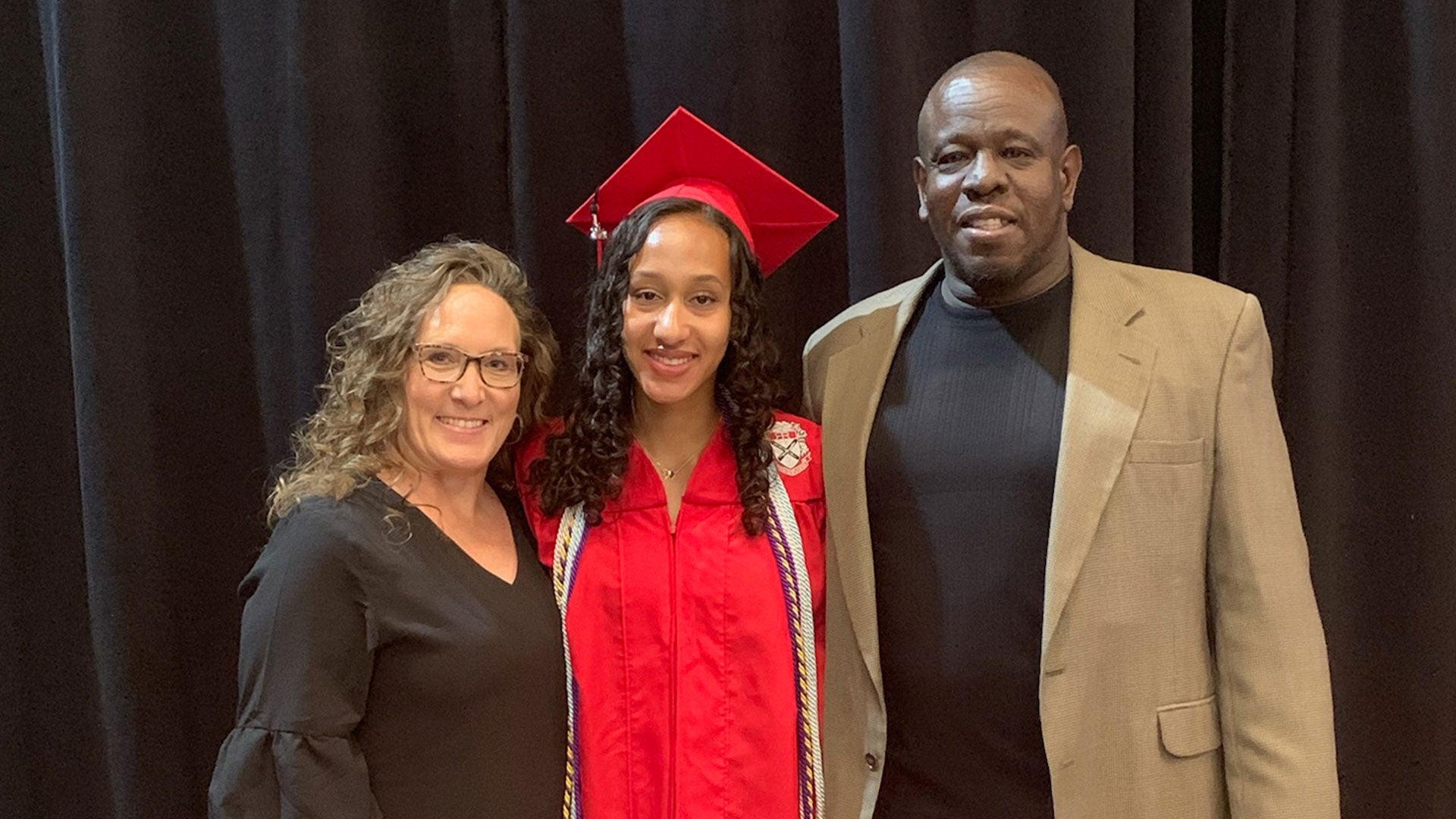 Ciara posing with parents at commencement