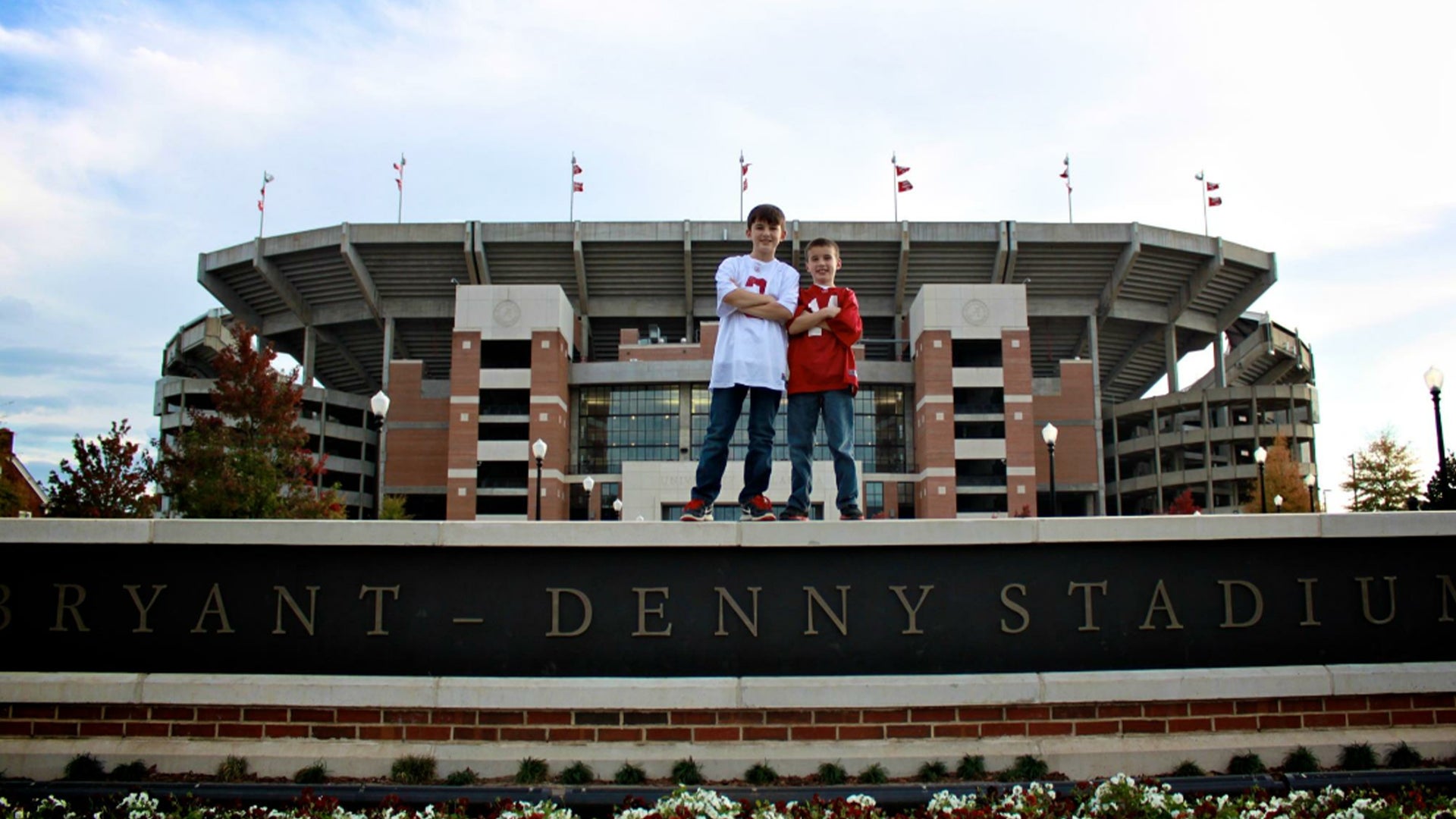 Riley and his brother standing in front of Bryant-Denny Stadium