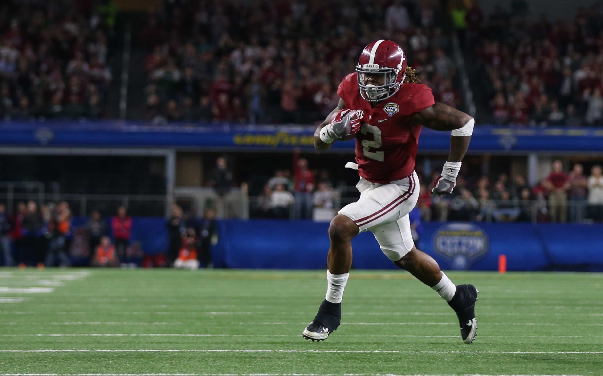 Alabama running back Derrick Henry runs downfield during the College Football Playoff Semifinal at the Cotton Bowl, breaking away from defenders