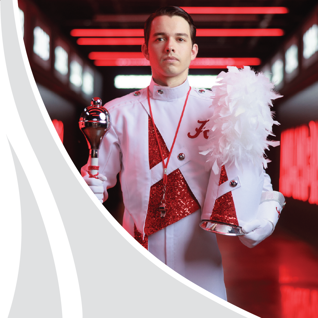 Million Dollar Band drum major in white-and-crimson uniform, holding a mace and plumed shako
