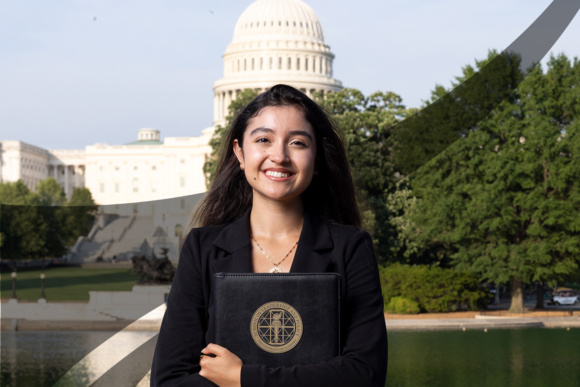 A student in a black blazer holds a School of Leadership and Policy portfolio by the Capitol reflecting pool