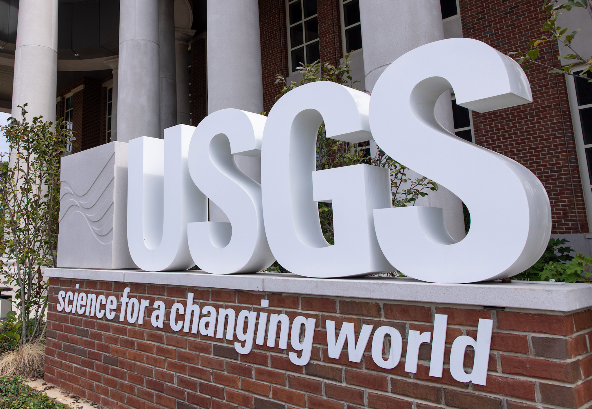 Large white USGS letters on a brick base reading